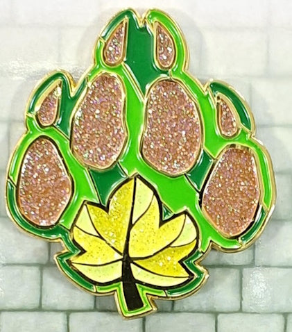 A 1.5-inch enamel pin with a green and brown color scheme, featuring a glittering design that represents the Druid character class.