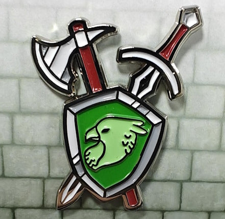 Soft enamel pin as the Dungeons and Dragons Fighter class. It shows a gray and white shield with a green Griffin head in the center. There are a single-head battle axe and a sword crossed behind the shield. The sword and battle axe are white, gray and red.
