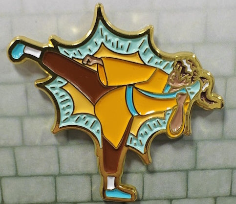 Soft enamel pin showing a Wizard's open spell book, with 3 shades of glittery blue magic swirling above it.