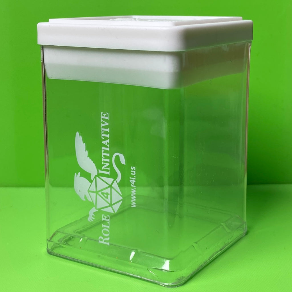 Large plastic box for displaying D&D dice or miniatures. It's a clear box with the Role 4 Initiative griffin logo imprinted in white on 1 side, and a white plastic lid with a raised griffin w/ d20 logo and a raised lip for easy stacking of multiple boxes.