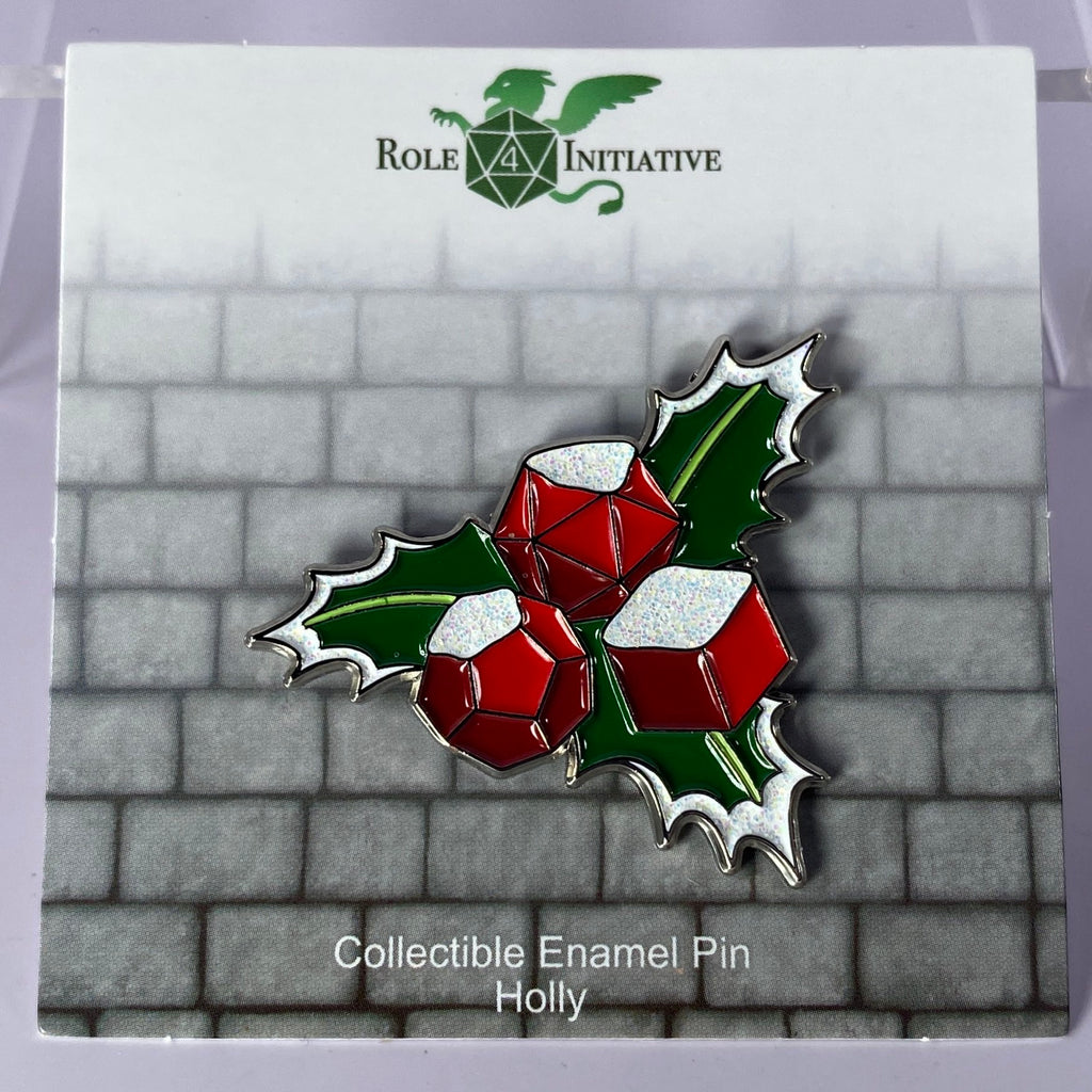 A soft enamel pin with a festive holly leaf and dice berries, reminding us of the most wonderful time of the year. A Holly and Jolly dicemas to all! 